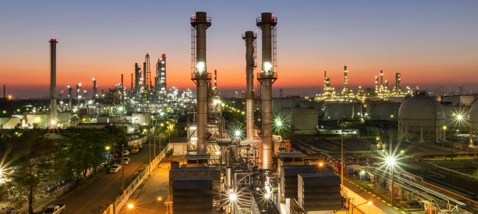 A large oil refinery with lights on at night.